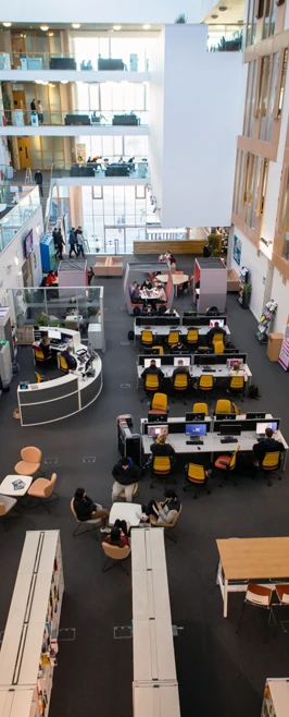Overhead view of Glasgow Kelvin College Springburn Campus library and flexible learning space with computer stations, bookshelves, and group seating. Overhead view of Glasgow Kelvin College Springburn Campus library and flexible learning space with computer stations, bookshelves, and group seating.